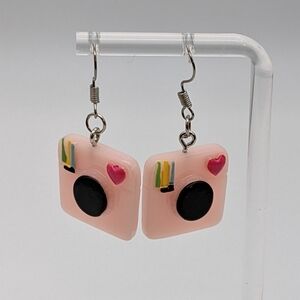 Pink drop earrings with Instagram camera logo and heart.
